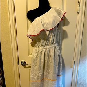 One shoulder, long, white sundress with colorful trim.